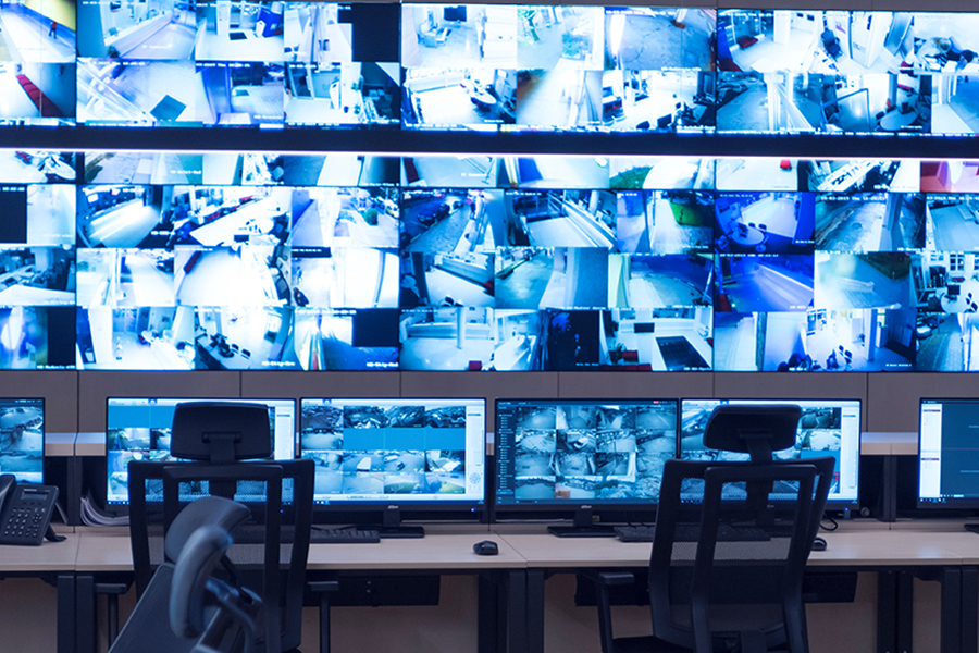 Security guard monitoring modern CCTV cameras in surveillance room operateur videoprotection bordeaux